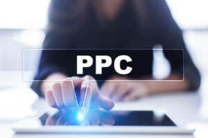 In this article that shares sustainable business growth options, this image shows a woman clicking on her tablet in a PPC image.