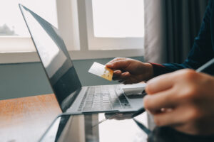 Person and their hand about to make an online purchase shopping online with a gift card